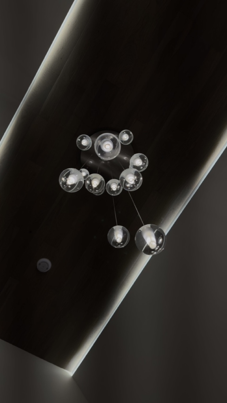 Cluster of clear glass bubble pendants in designer chandelier at Casa DOS