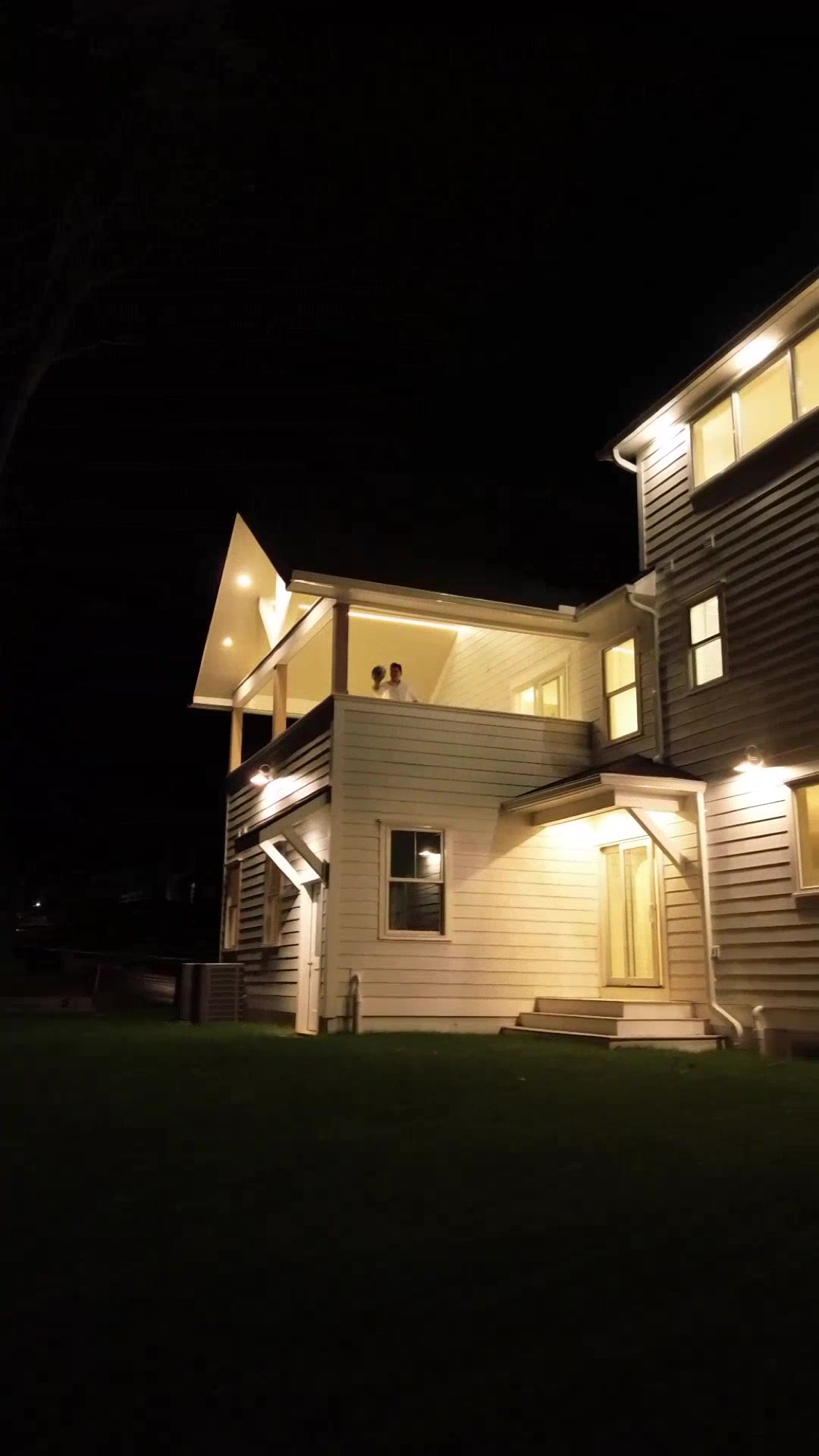 People gathered on a lit porch at Casa UNO — More Life Development