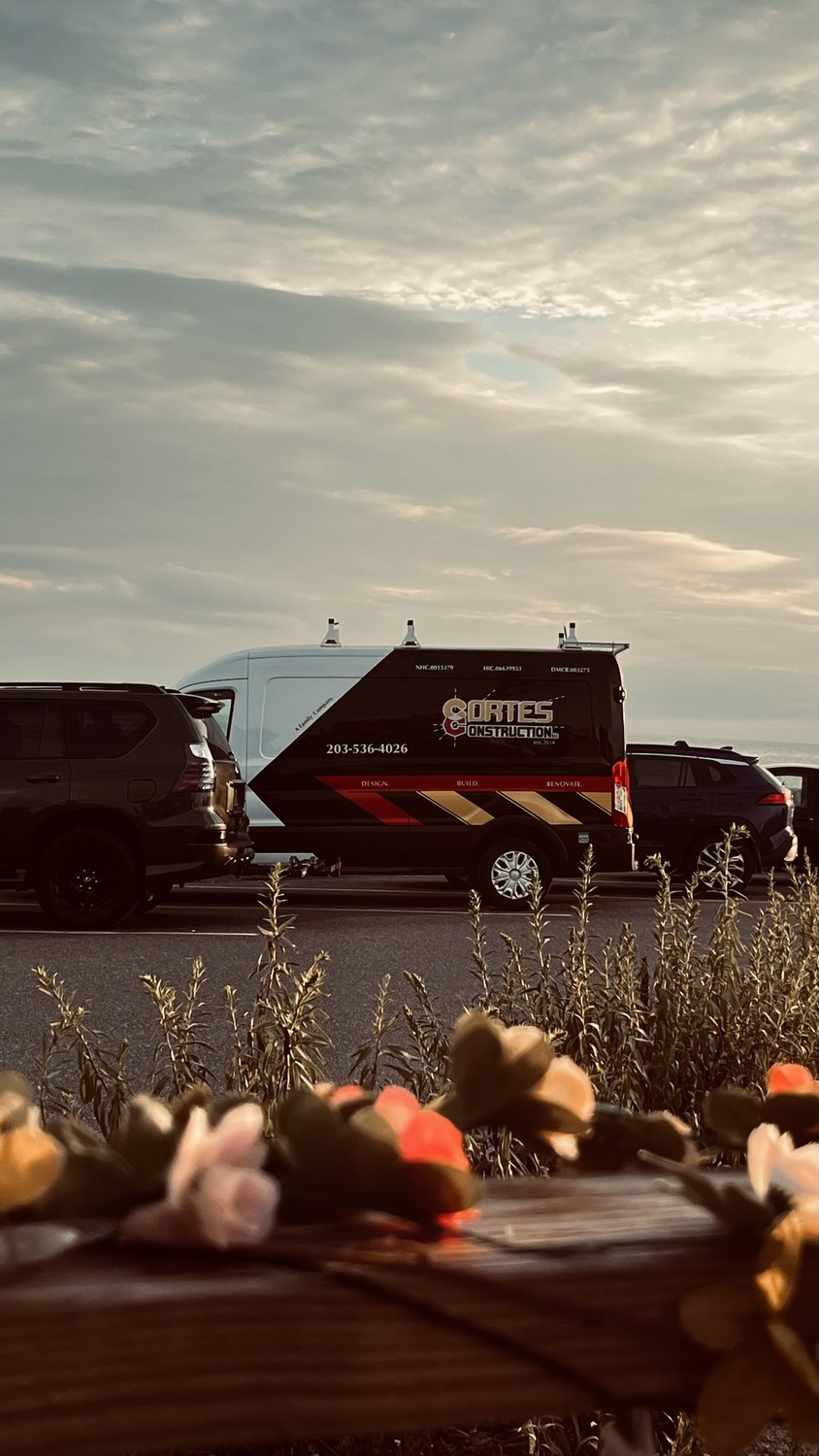 A Cortes Constructions van at the site, in color.
