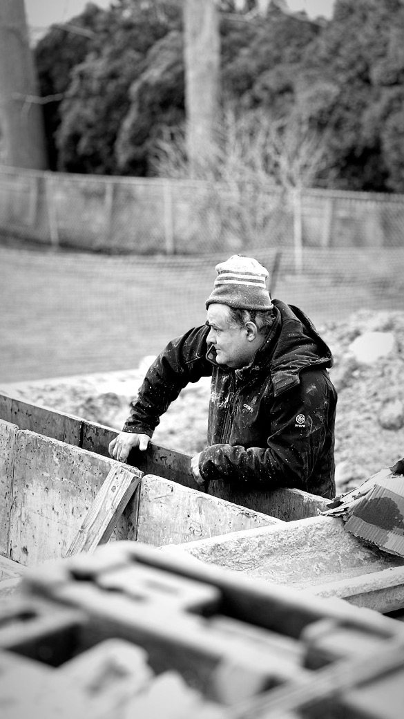 A builder at work on a More Life home, black and white.