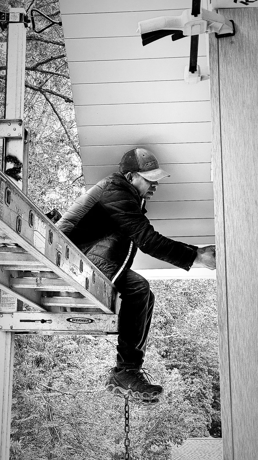 A builder at work on a More Life home, black and white.