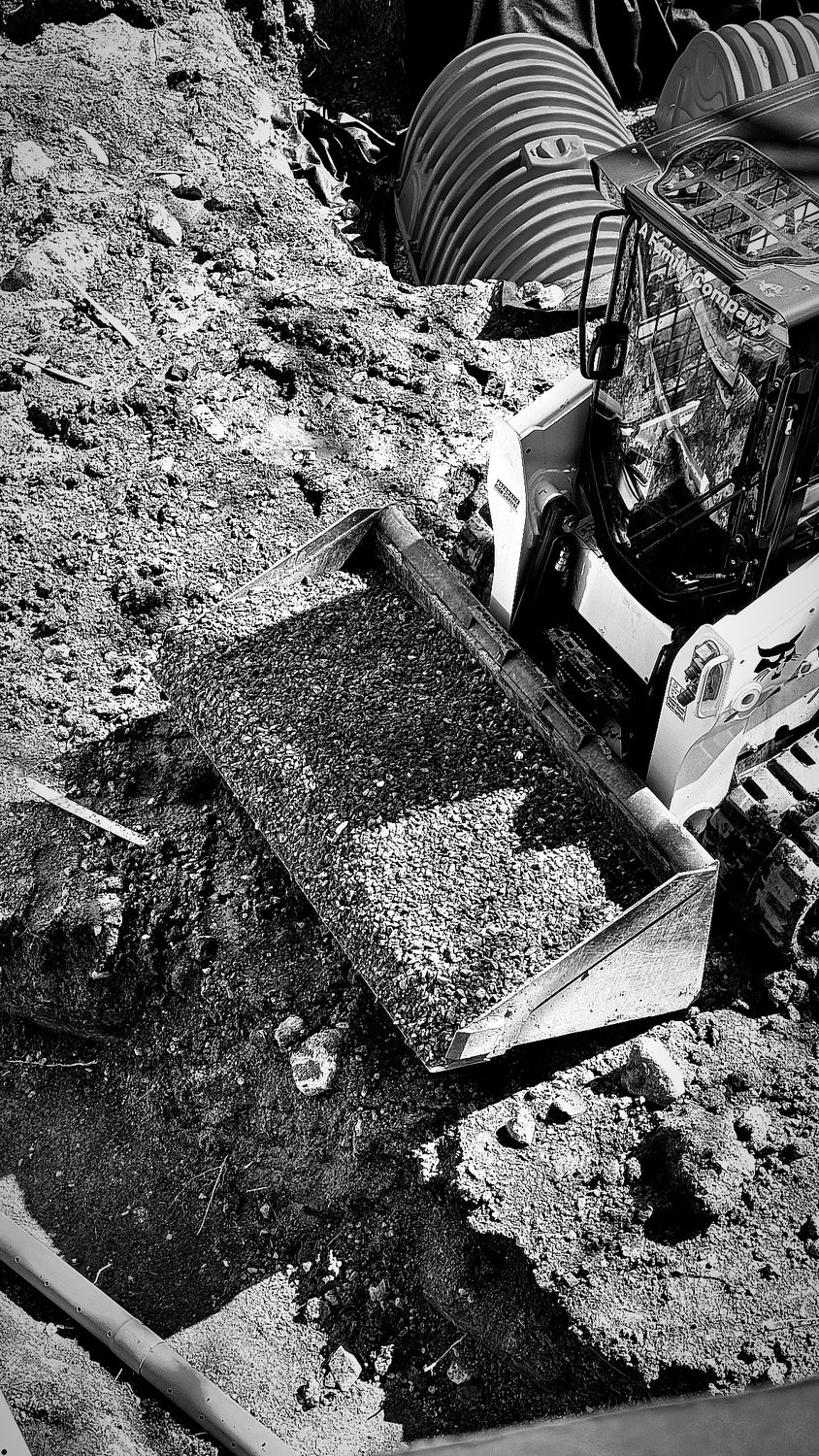A builder at work on a More Life home, black and white.