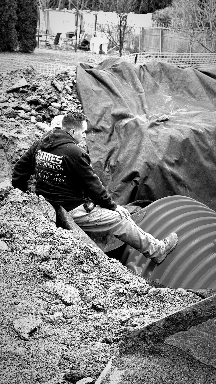 A builder at work on a More Life home, black and white.
