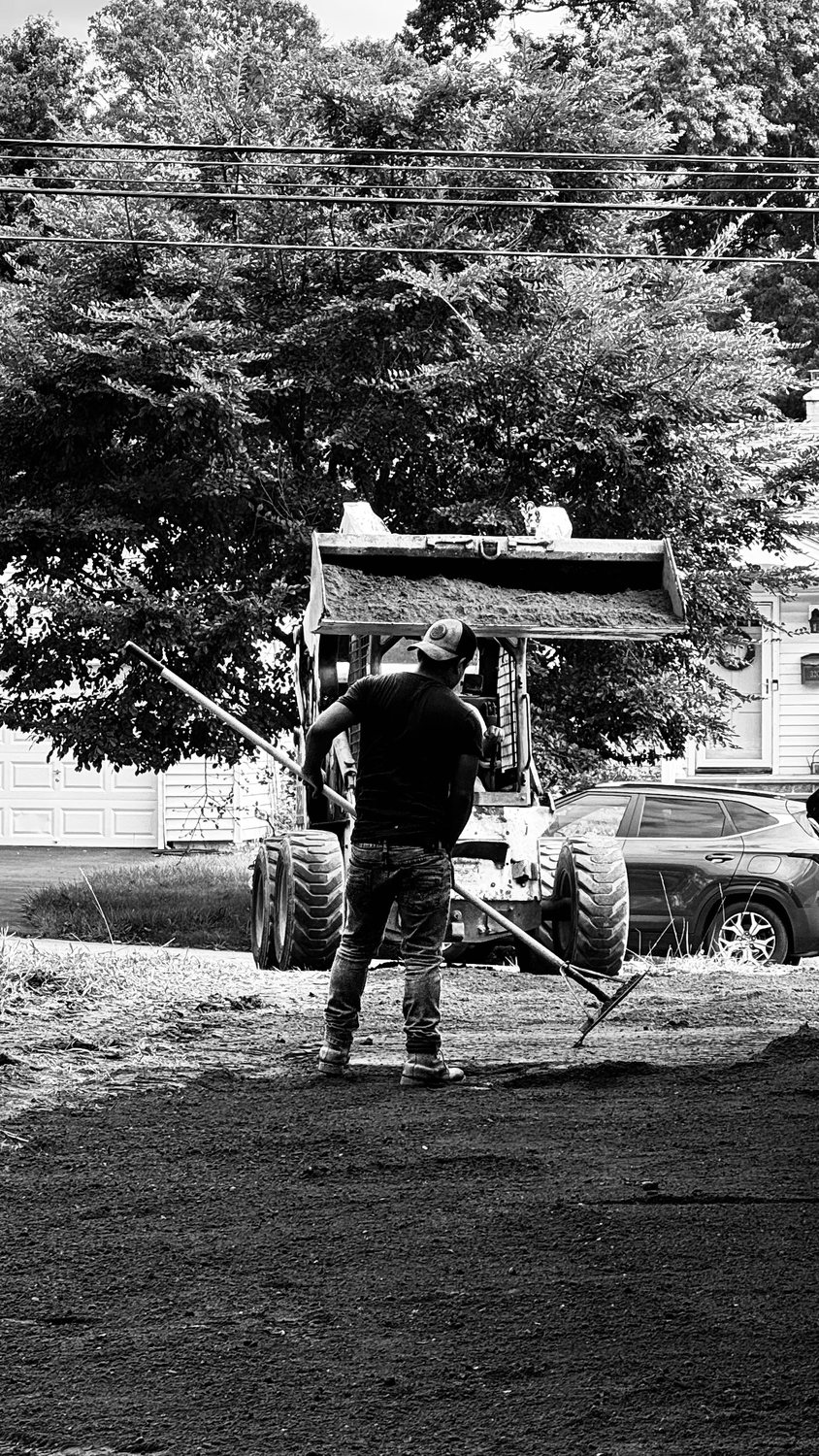 A builder at work on a More Life home, black and white.