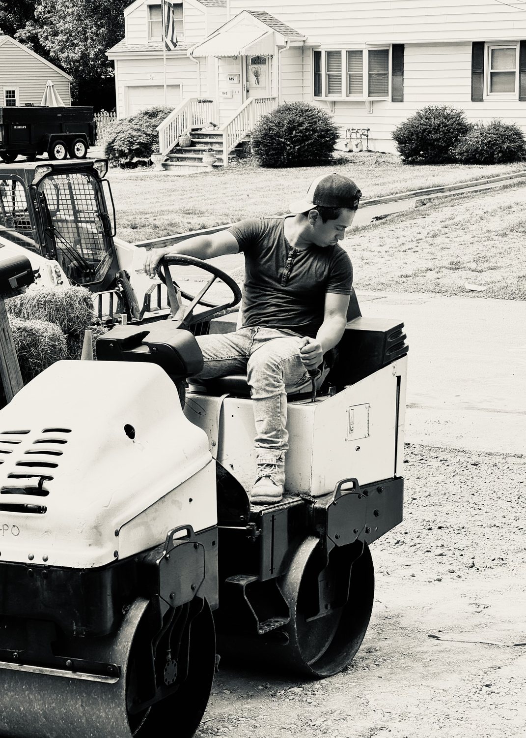 A builder at work on a More Life home, black and white.