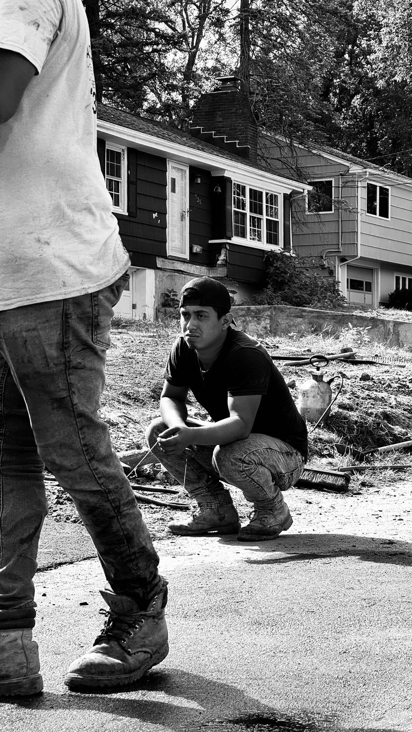 A builder at work on a More Life home, black and white.
