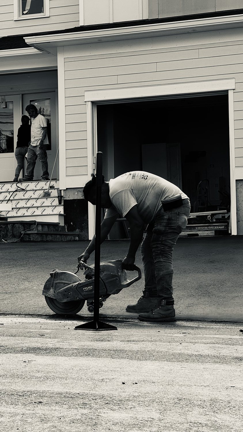 A builder at work on a More Life home, black and white.