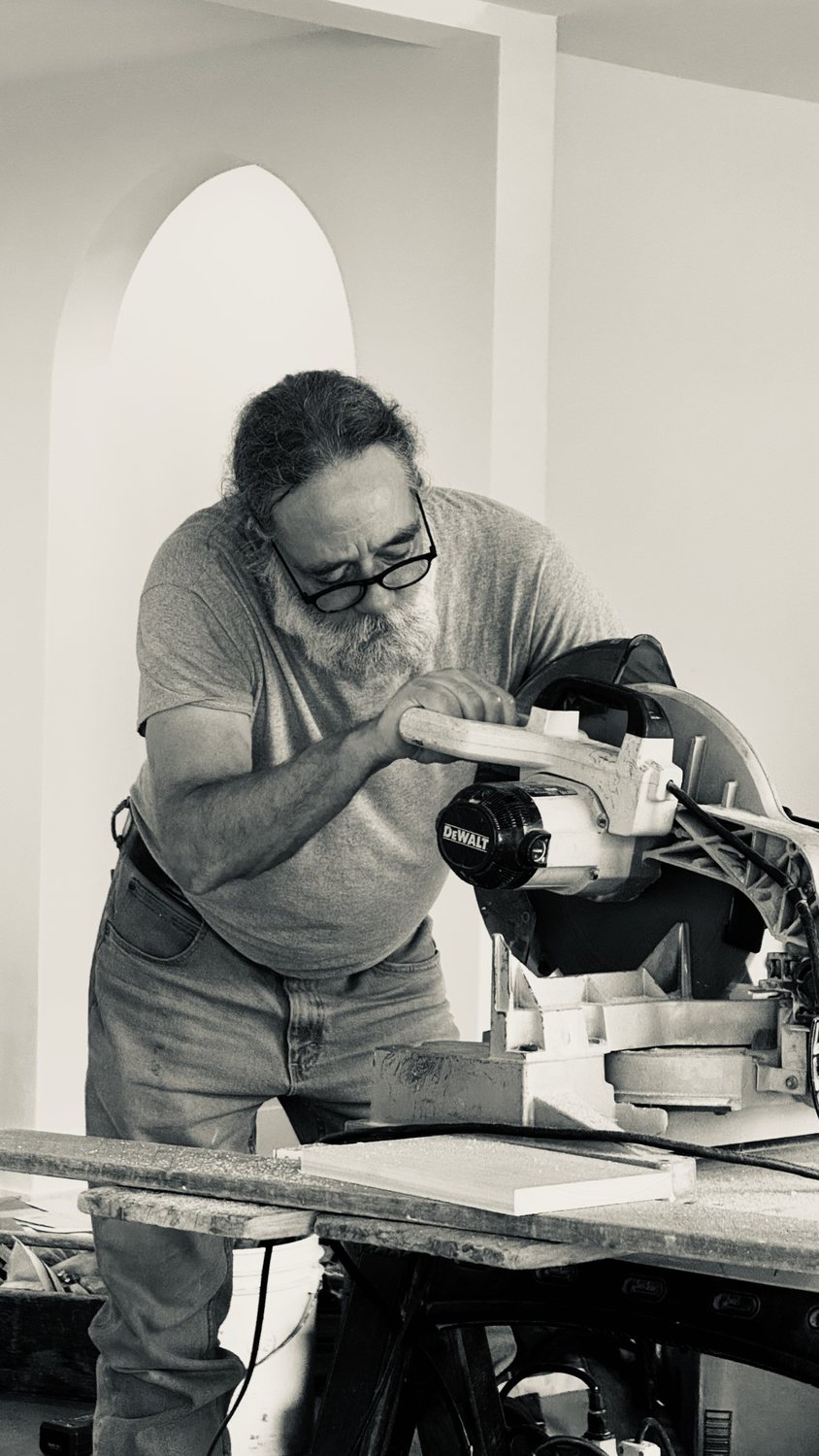 A builder at work on a More Life home, black and white.