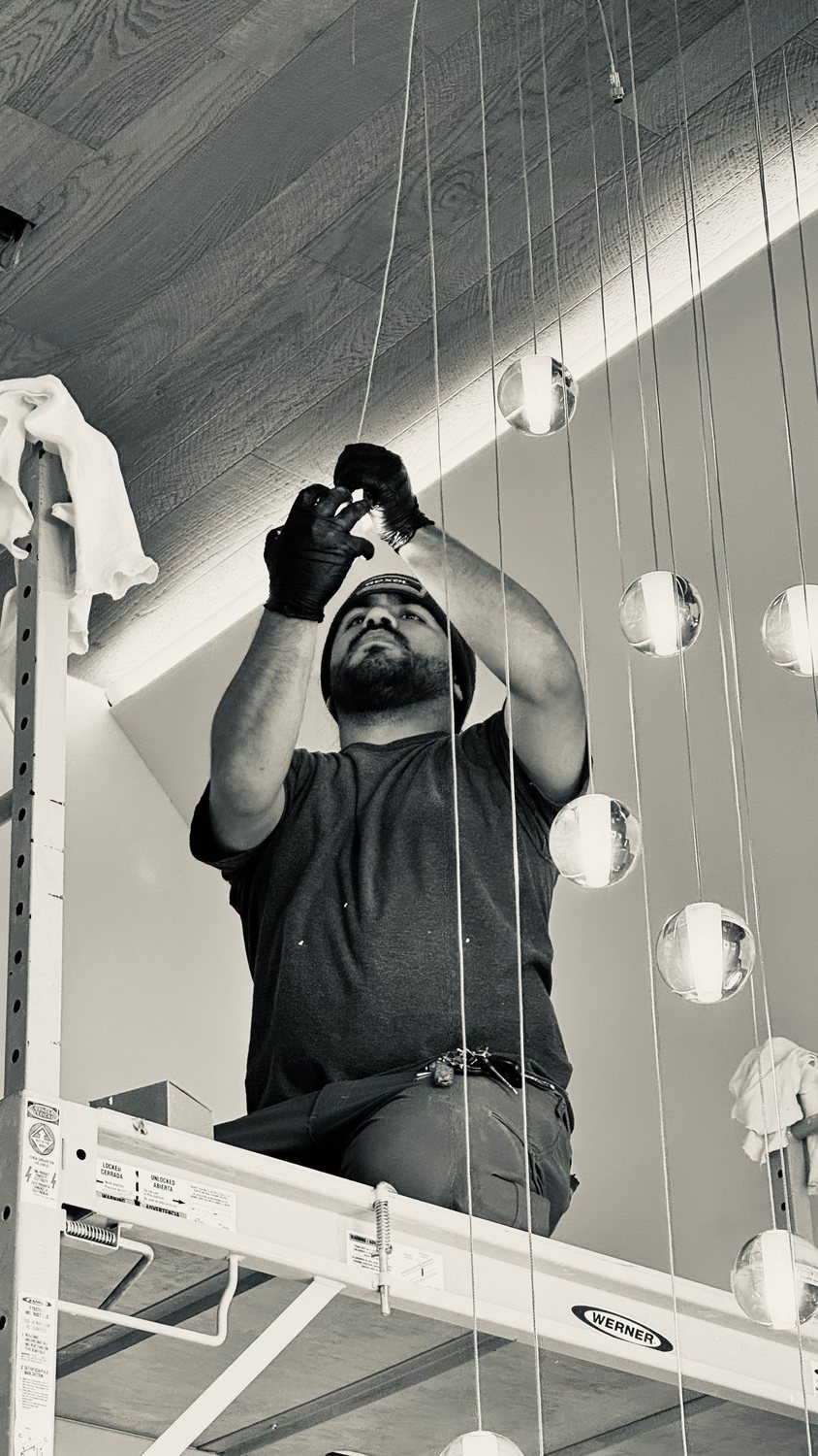A builder at work on a More Life home, black and white.