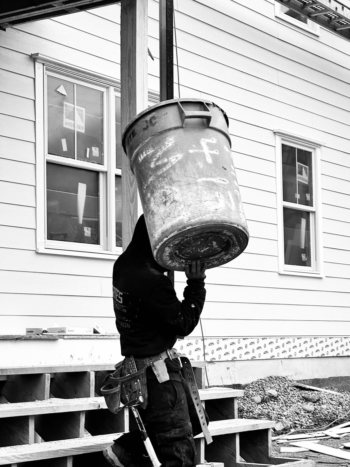 A builder at work on a More Life home, black and white.