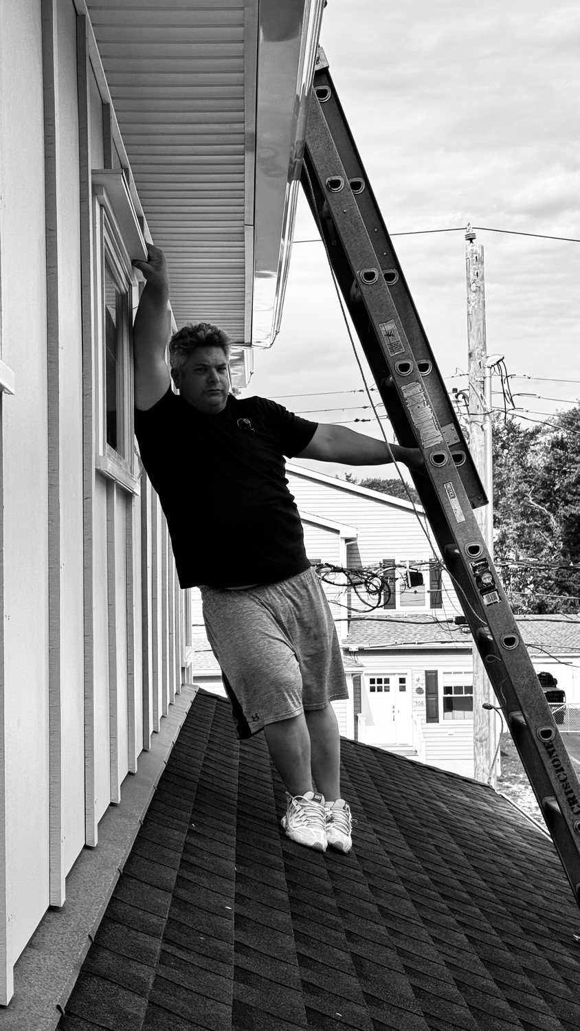 A builder at work on a More Life home, black and white.