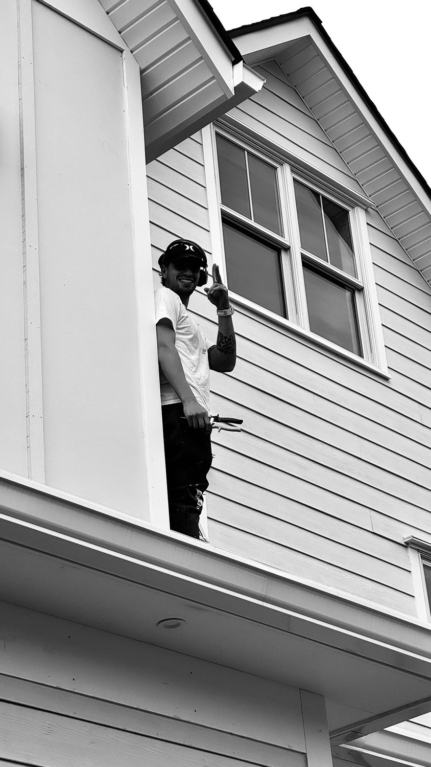 A builder at work on a More Life home, black and white.