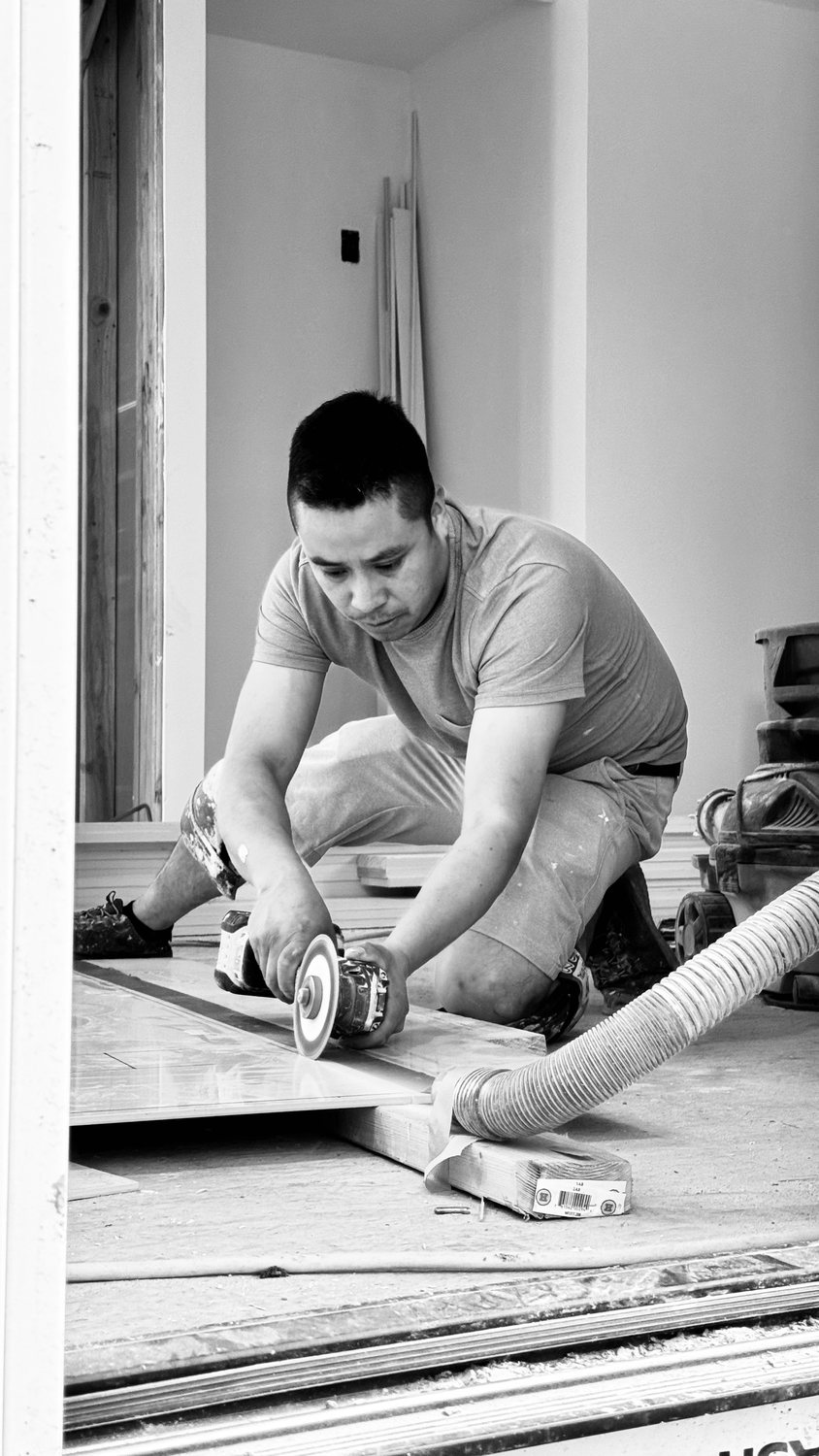 A builder at work on a More Life home, black and white.