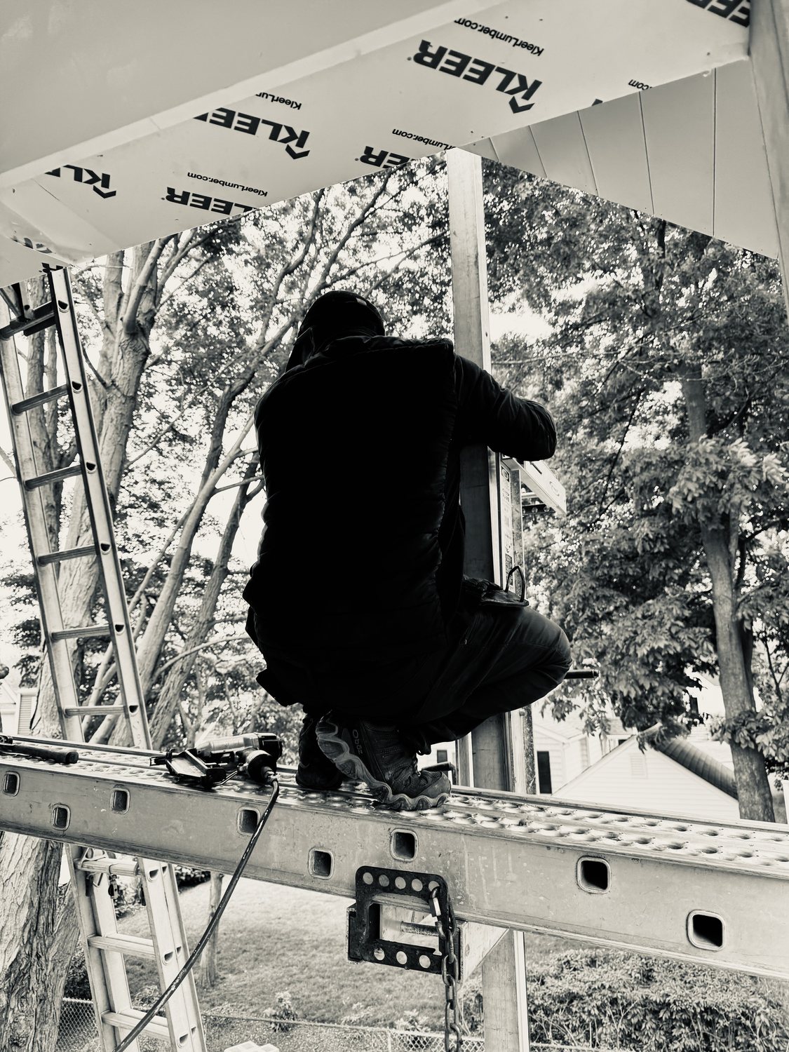 A builder at work on a More Life home, black and white.