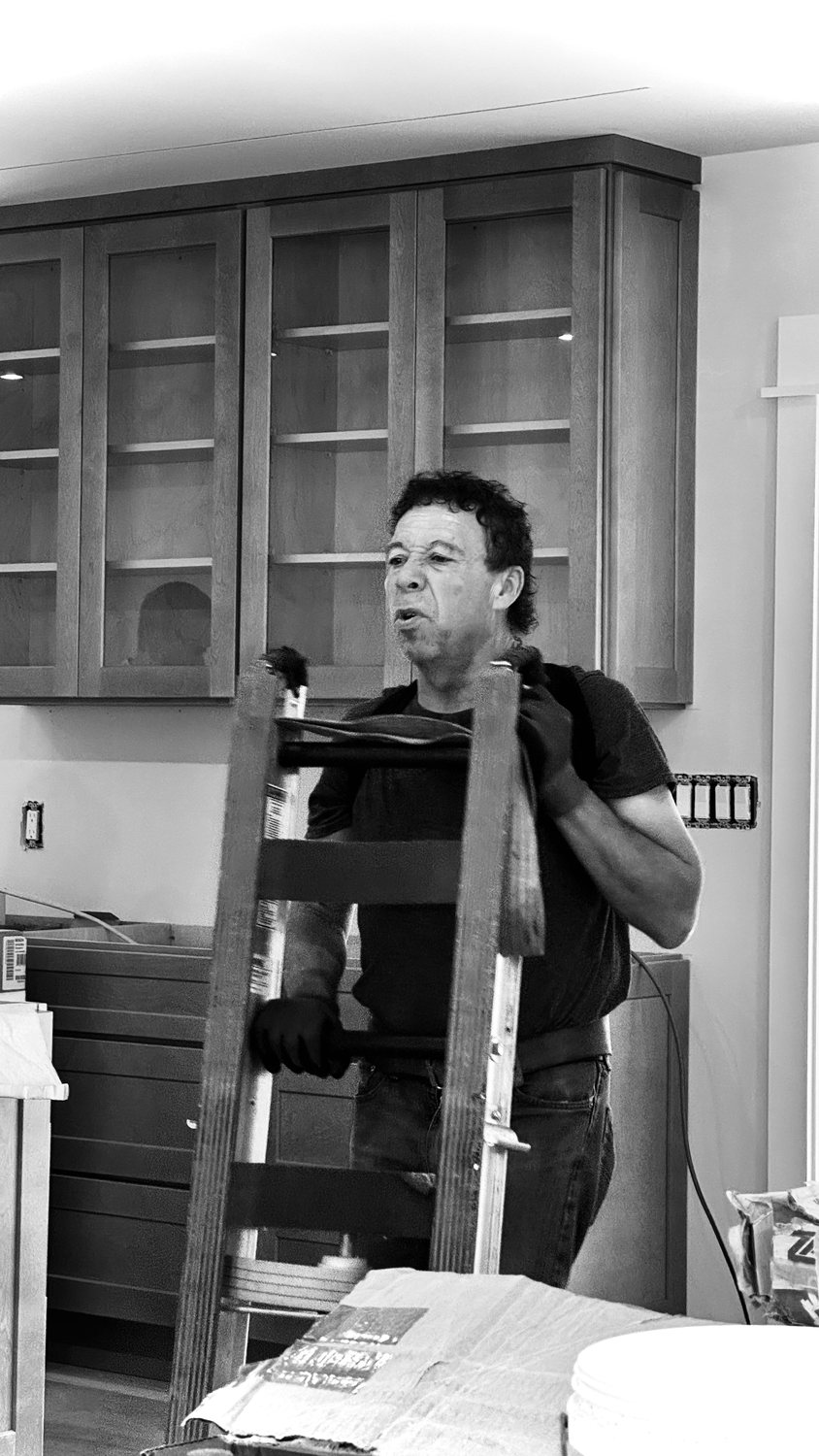A builder at work on a More Life home, black and white.