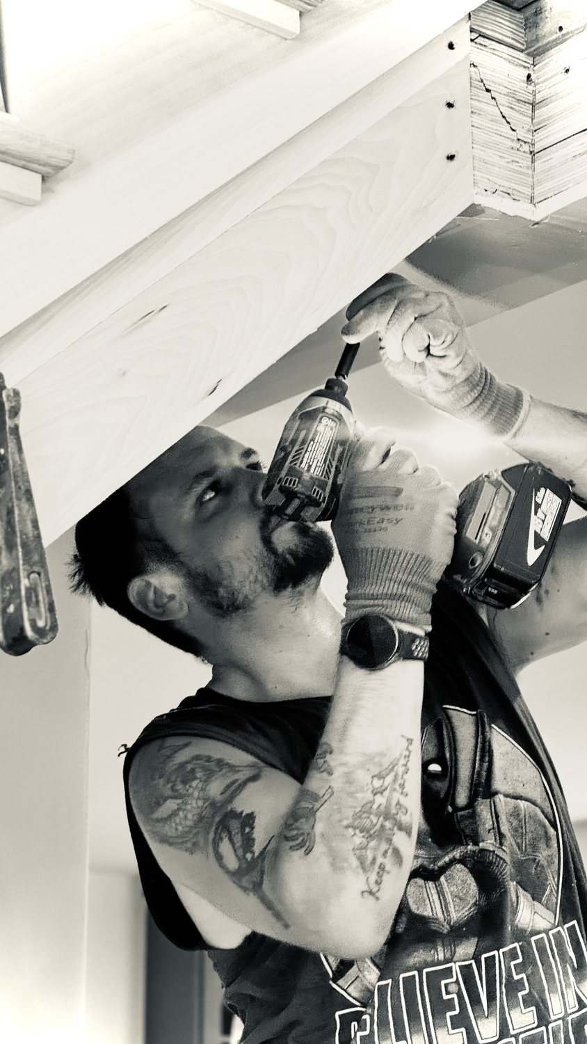 A builder at work on a More Life home, black and white.