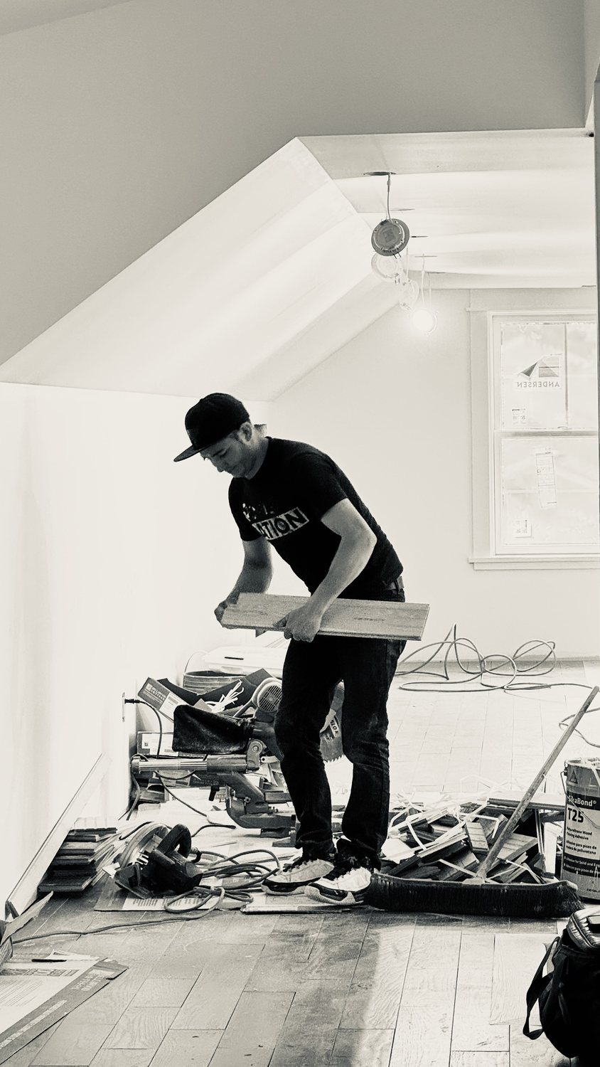 A builder at work on a More Life home, black and white.