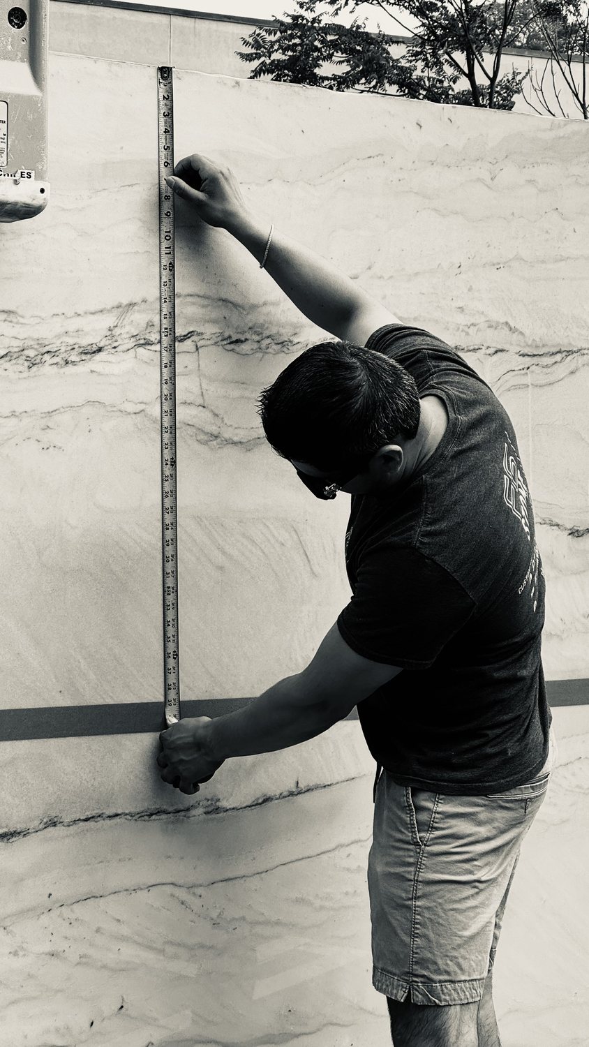 A builder at work on a More Life home, black and white.